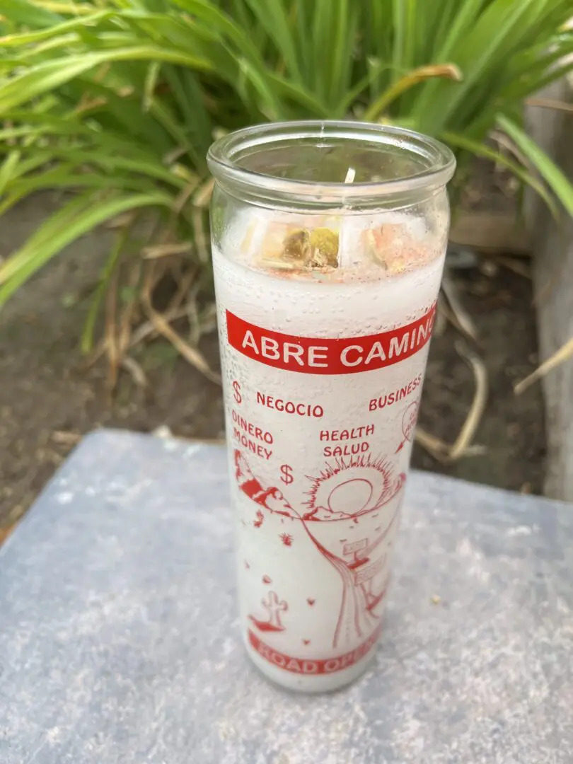 A candle that is sitting on the ground. A candle that is sitting on the ground.