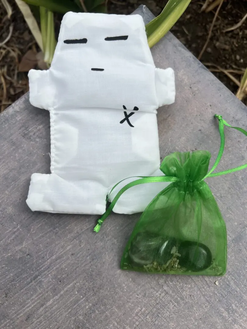 A white bag with green string and a small bag A white bag with green string and a small bag
