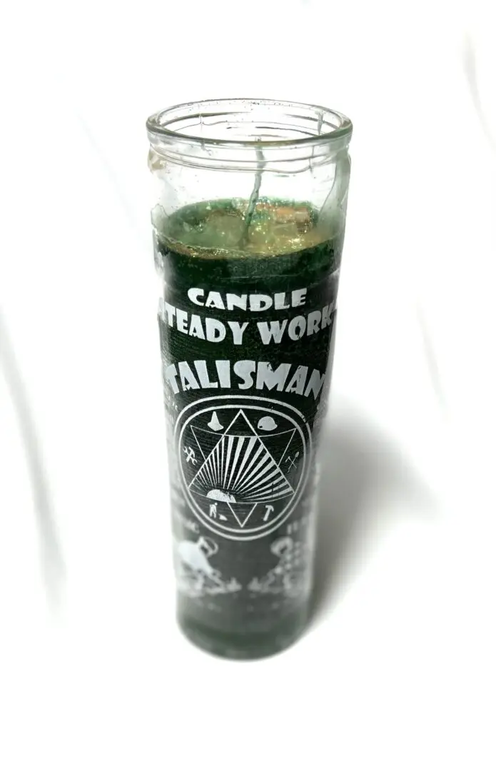 A candle that is sitting in the glass. A candle that is sitting in the glass.