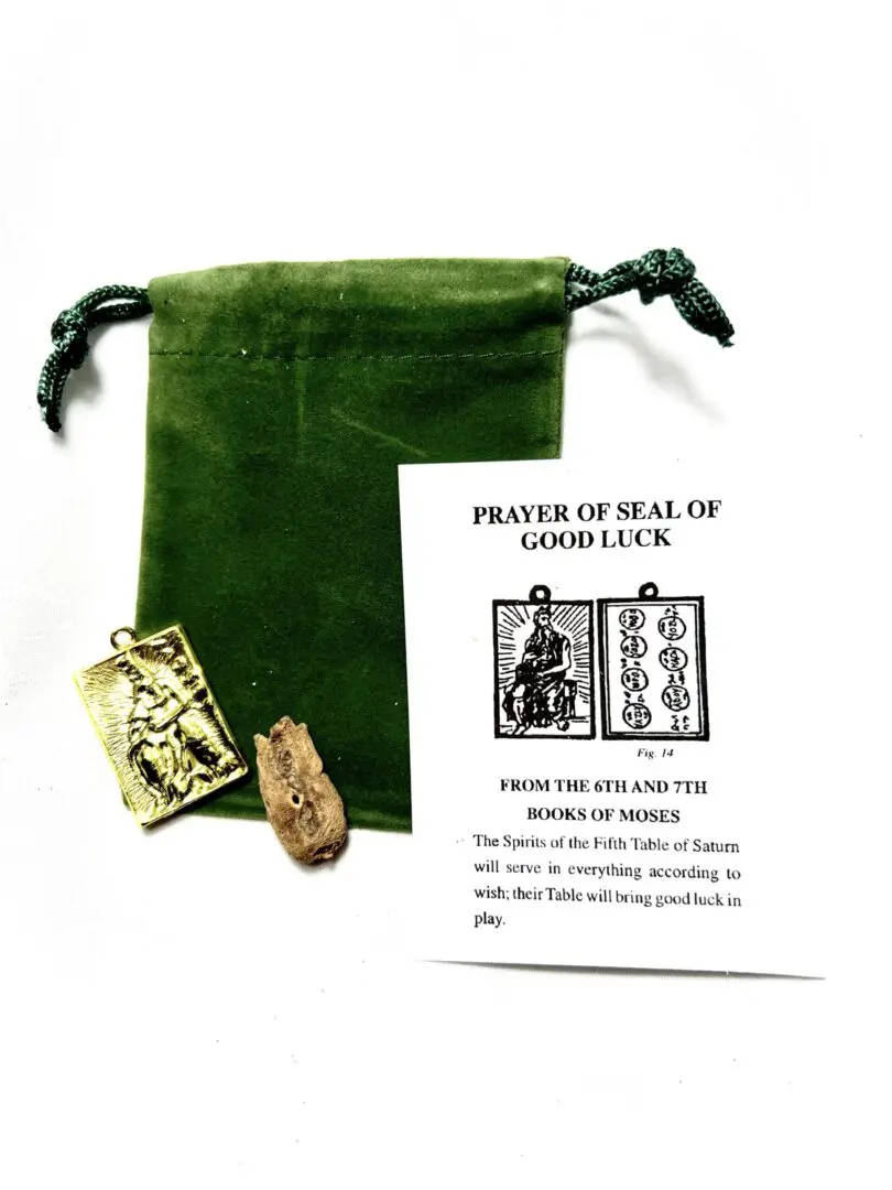 A green bag with some papers and a small gold object A green bag with some papers and a small gold object