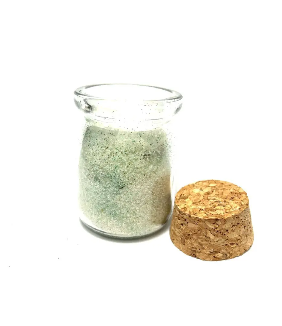 A glass jar with some type of substance in it A glass jar with some type of substance in it