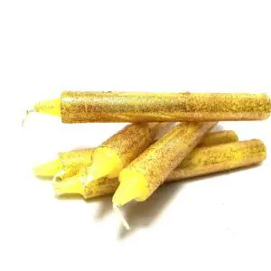 A pile of yellow candles on top of each other.