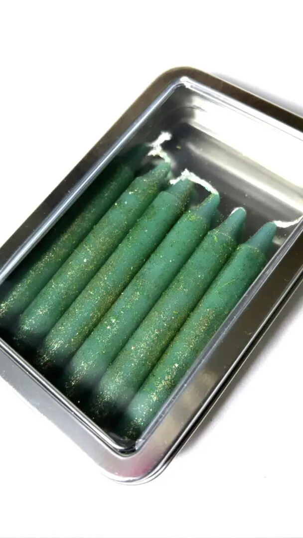 A box of green candles in it A box of green candles in it