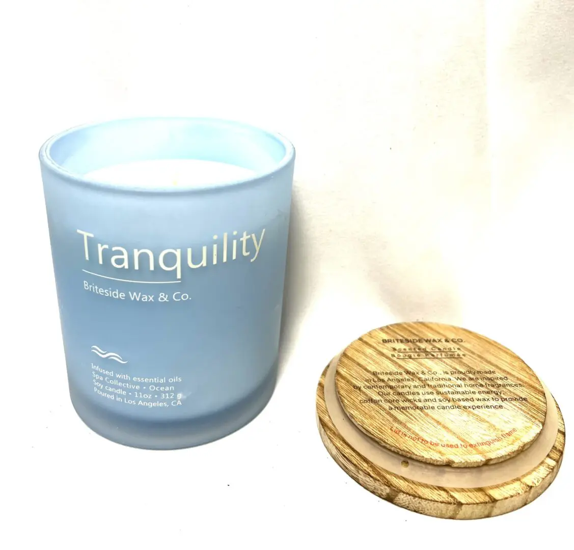 A candle and some wood coasters on the table A candle and some wood coasters on the table