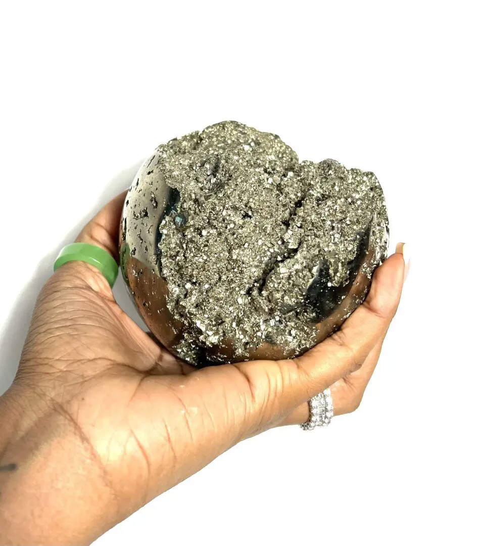A person holding a rock in their hand. A person holding a rock in their hand.