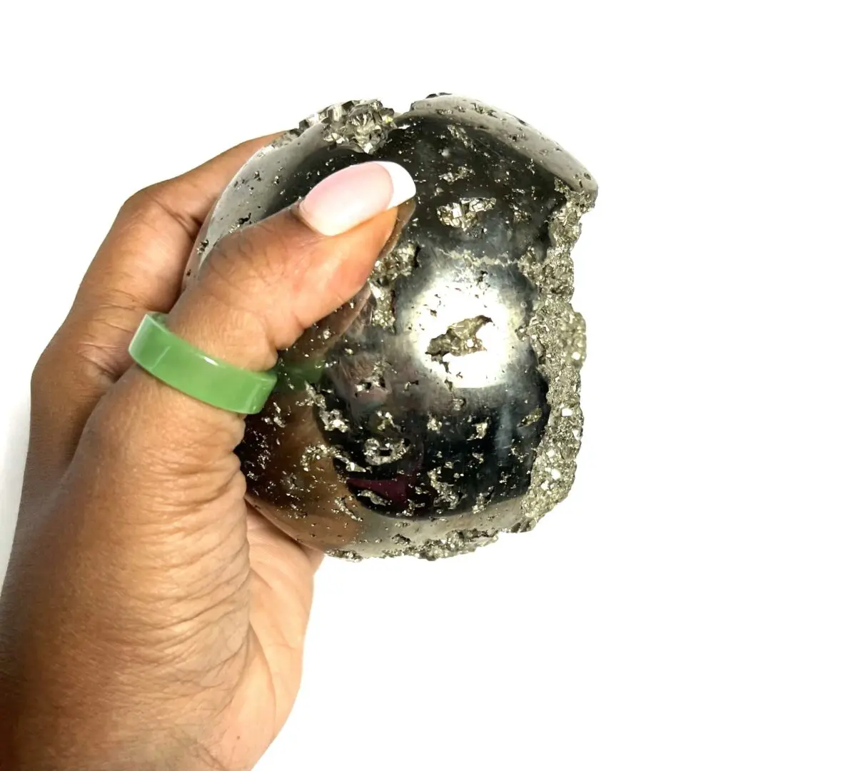 A person holding onto a rock with a green ring around it. A person holding onto a rock with a green ring around it.