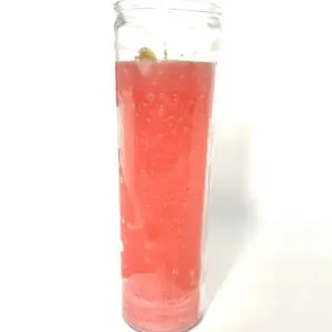 A candle with pink liquid in it.