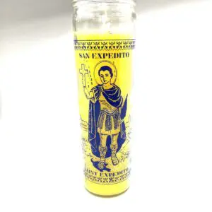 A yellow candle with an image of a man holding something.