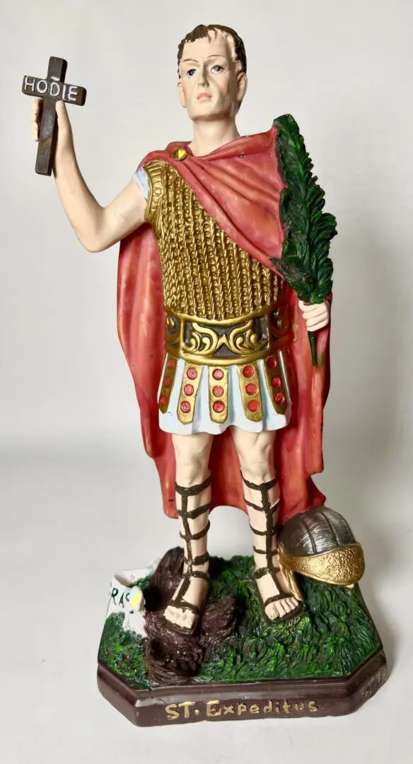 A statue of a roman soldier holding a sword. A statue of a roman soldier holding a sword.