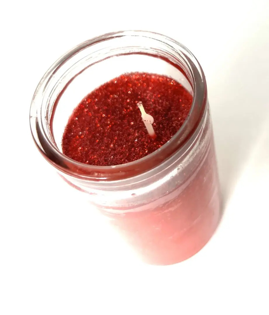 A candle is lit in the middle of a jar. A candle is lit in the middle of a jar.