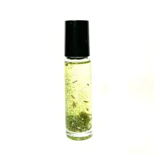 A bottle of oil with some green stuff in it