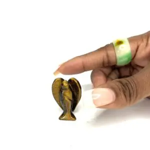 A hand holding an object in the shape of a heart.