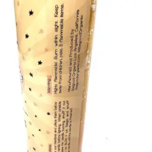 A tube of lotion with black dots on it.