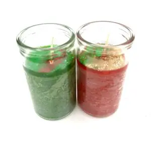 Two candles are sitting side by side on a table.