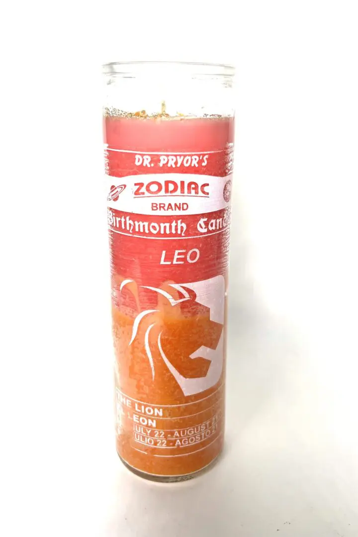 A candle that is sitting on the floor. A candle that is sitting on the floor.