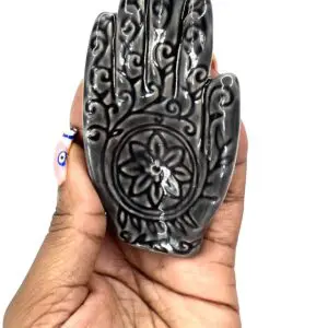 A hand with a flower carved on it