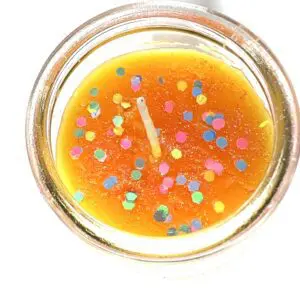 A candle with colored candles in it