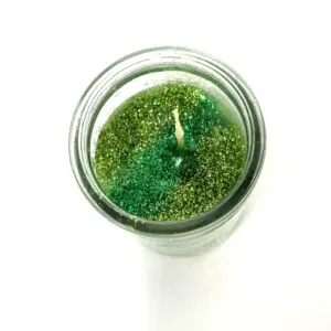 A candle is sitting in a glass jar.