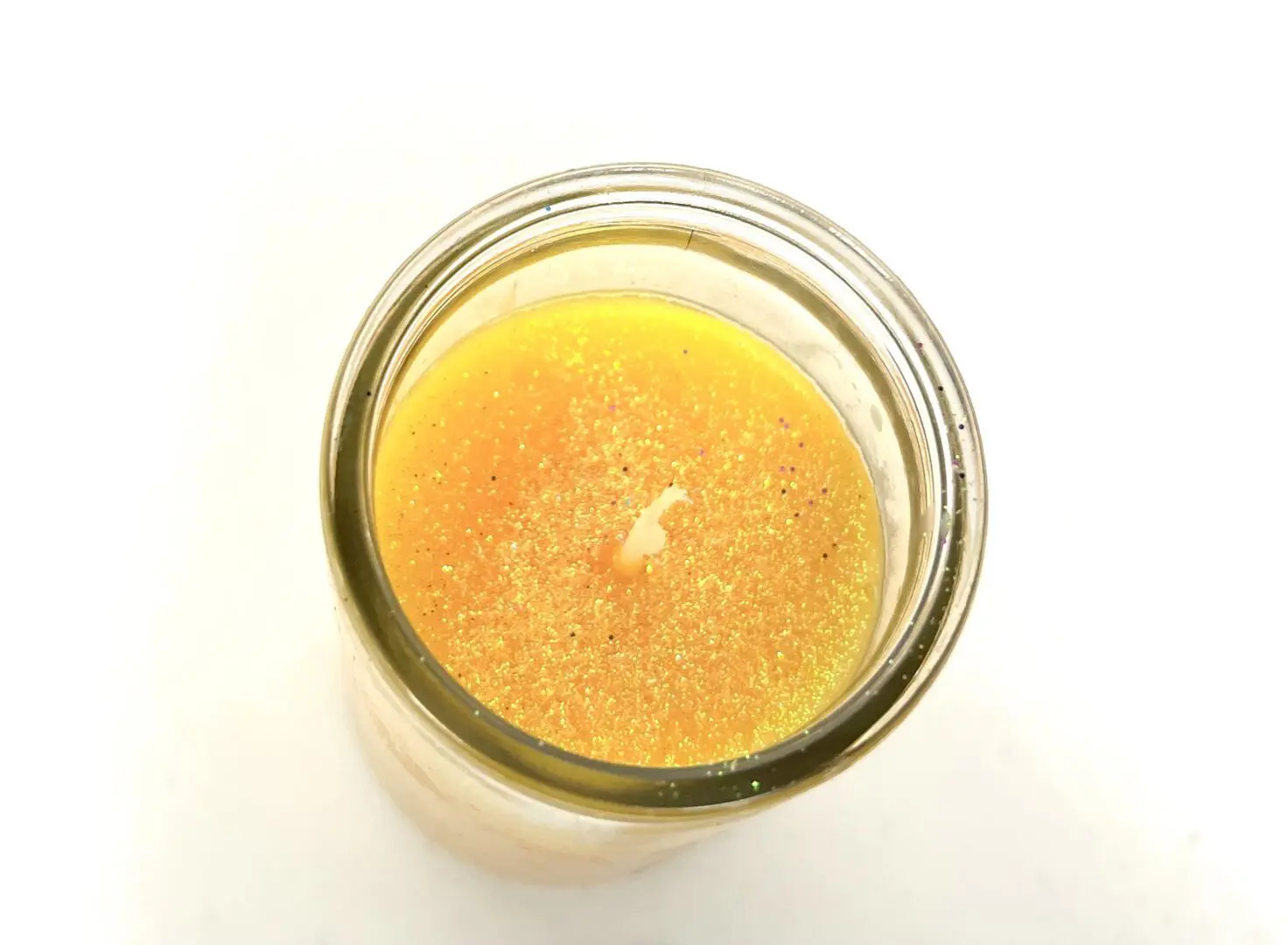 A jar of orange juice on top of a table. A jar of orange juice on top of a table.