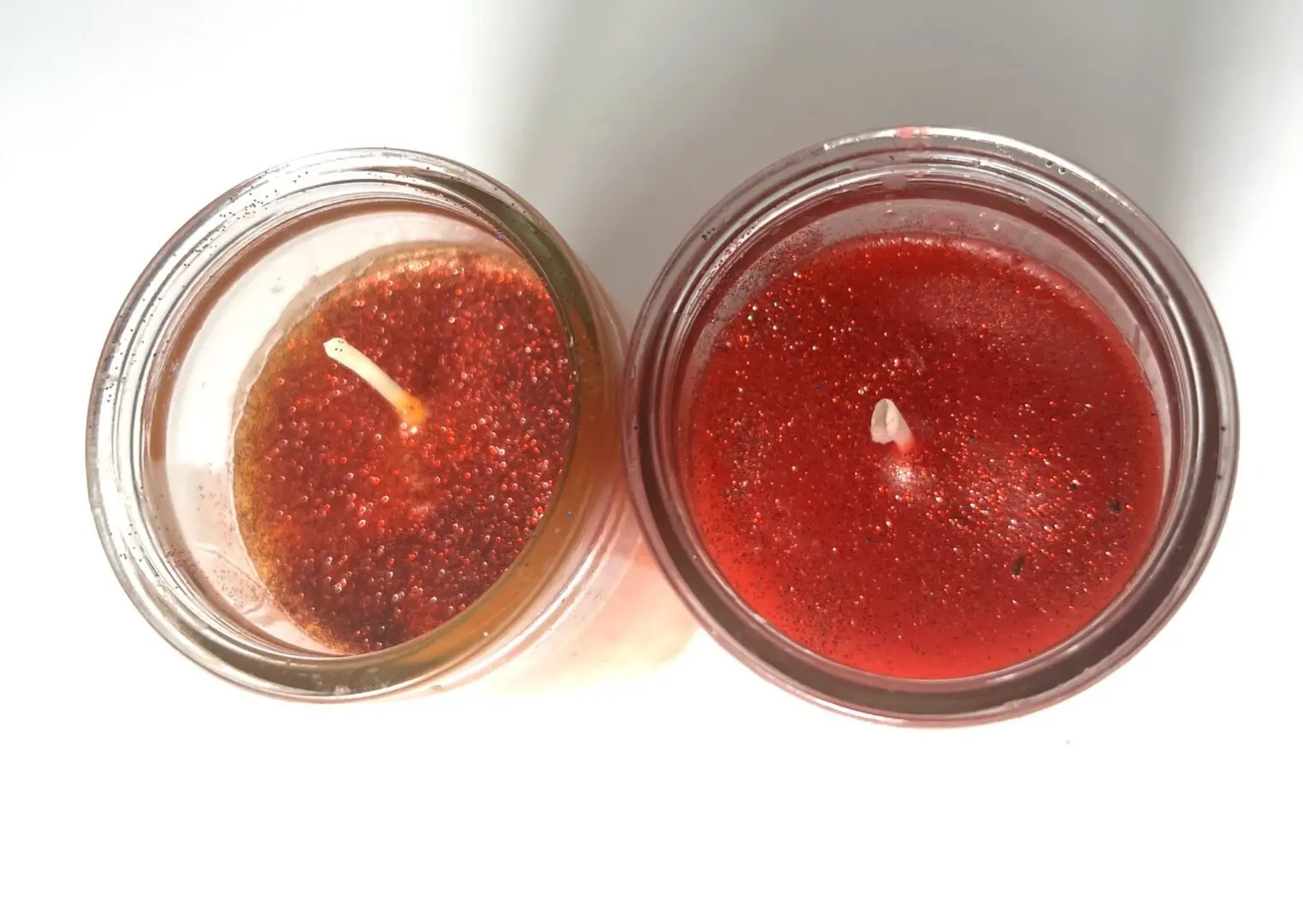 Two candles are sitting next to each other. Two candles are sitting next to each other.