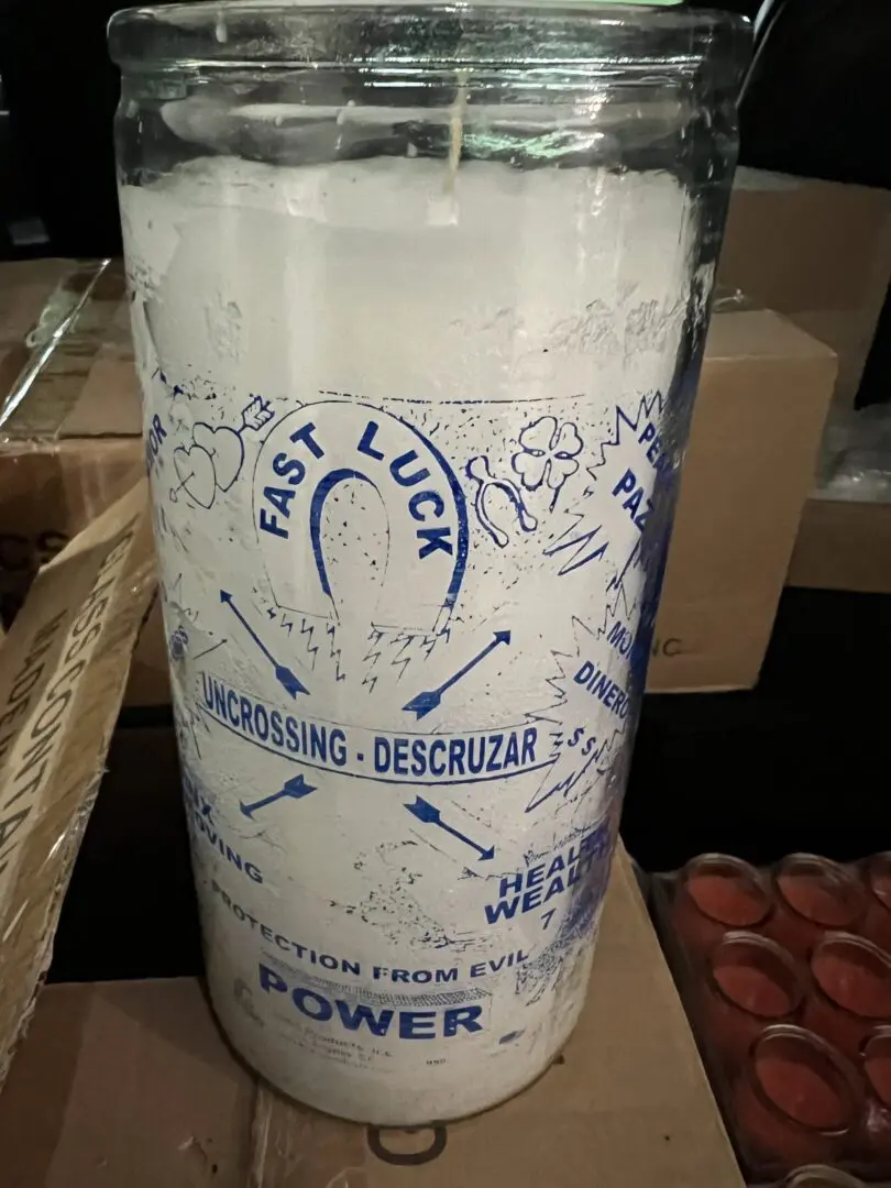 A candle that is sitting on some cardboard. A candle that is sitting on some cardboard.