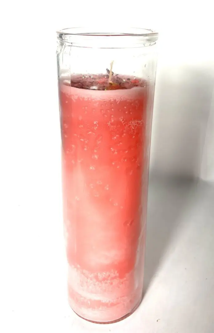 A glass of pink liquid with ice in it. A glass of pink liquid with ice in it.