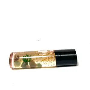 A clear tube of lip gloss with green leaves.