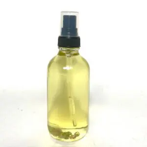 A bottle of oil sitting on top of a table.