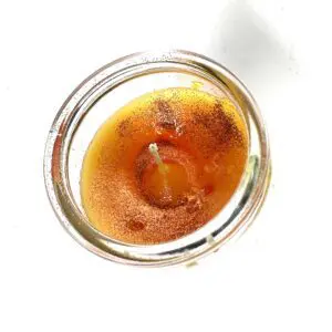 Candle with gold glitter in a jar.