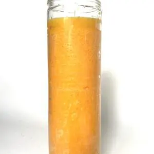 Orange scented candle in a glass jar.