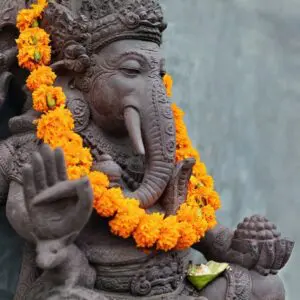 Ganesha statue with flower garland.