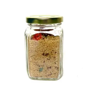 Glass jar filled with brown sugar and fruit.