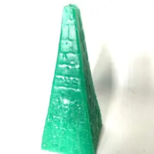 Green pyramid-shaped candle on white background.