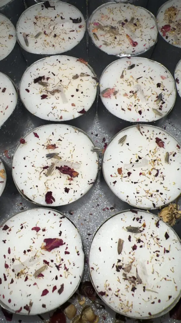 Handmade candles with dried flower decorations on top. Handmade candles with dried flower decorations on top.