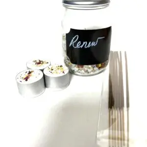 A jar labeled 'Renew' with coffee pods and stir sticks beside it.