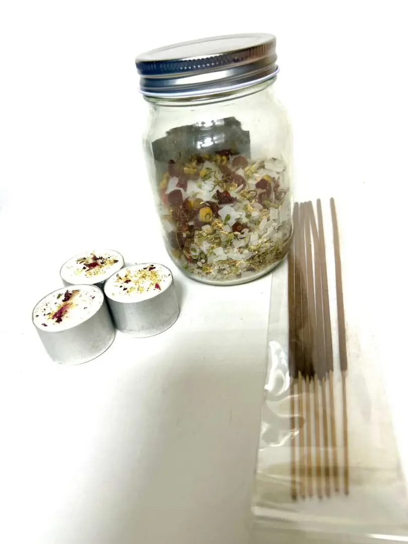 Sushi rolls, chopsticks, and a jar of dried ingredients on a white surface. Sushi rolls, chopsticks, and a jar of dried ingredients on a white surface.