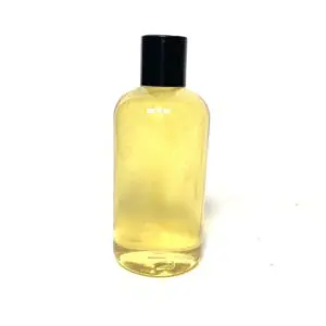Clear bottle filled with yellow liquid and black cap.