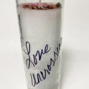 Tall candle with 'Love Universe' written in purple handwriting.