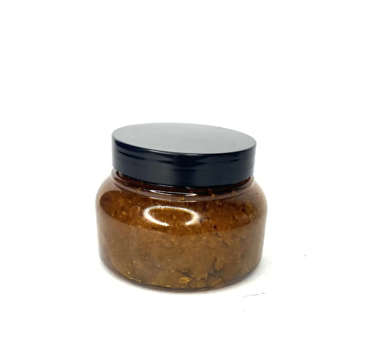 A small glass jar filled with brown paste and a black lid. A small glass jar filled with brown paste and a black lid.