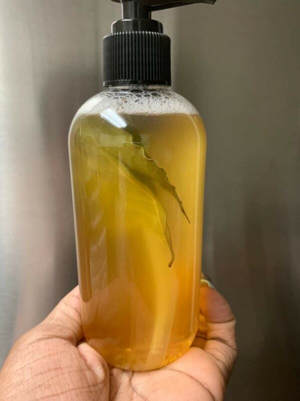 Yellow liquid soap bottle with leaf.