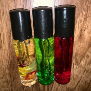 Three glass bottles of colorful liquid.