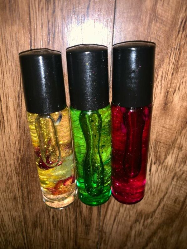 Three glass bottles of colorful liquid.