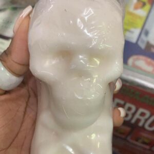 White skull-shaped soap in hand.