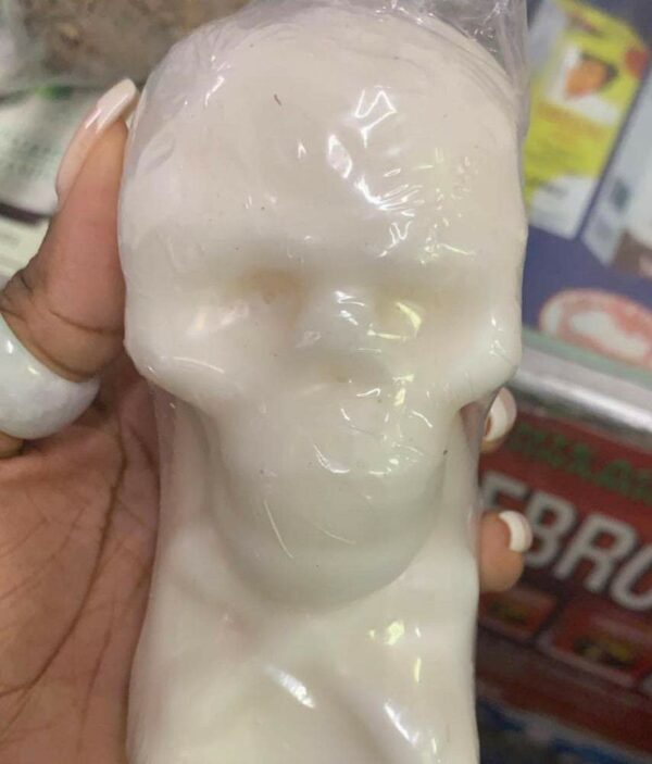 White skull-shaped soap in hand.