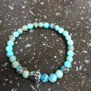 Blue gemstone bracelet with Buddha charm.