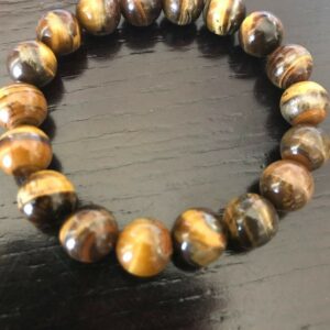 Tiger's eye bead bracelet on wooden surface.