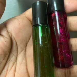 Two bottles of green and pink glitter oil.