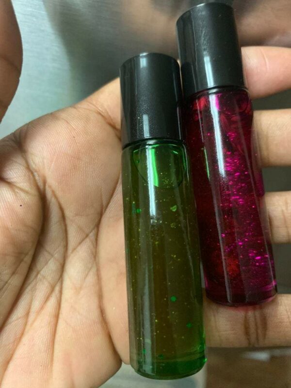 Two bottles of green and pink glitter oil.