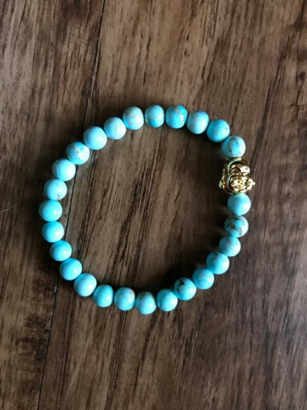 Blue turquoise beaded bracelet with gold charm.