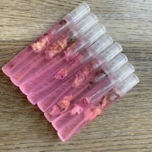 Pink perfume bottles with dried flowers.